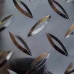 Close-up of high-gloss metallic black diamond tread garage flooring.