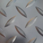 Close-up of matte grey diamond tread garage flooring.