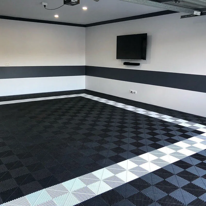 Dark gray garage tiles with white perimeter border.