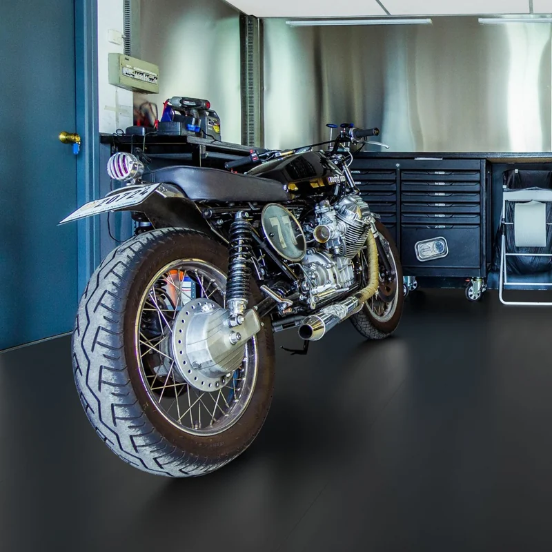 Vintage motorcycle on a sleek, matte black garage floor