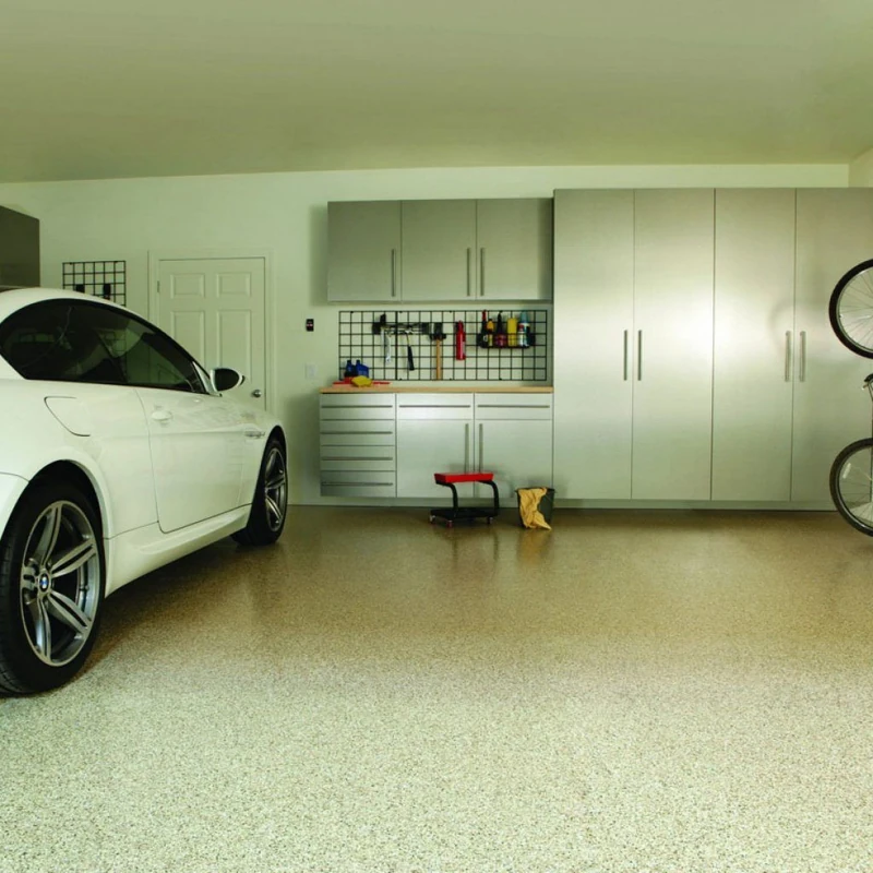White car in a clean garage with tan speckled flooring