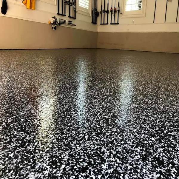 Durable epoxy garage flooring with black and white flecks.