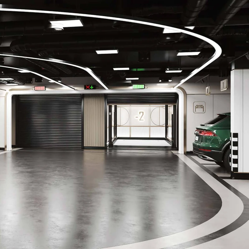 Modern garage with epoxy flooring, green car, and automated doors.