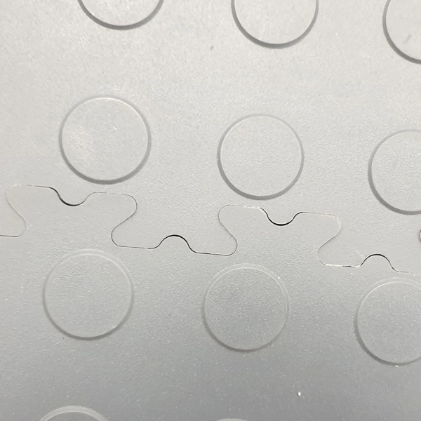 Gray interlocking PVC garage floor tiles with raised circles