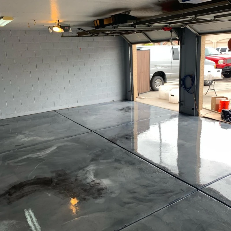 Shiny gray epoxy garage floor with metallic swirls and reflections.