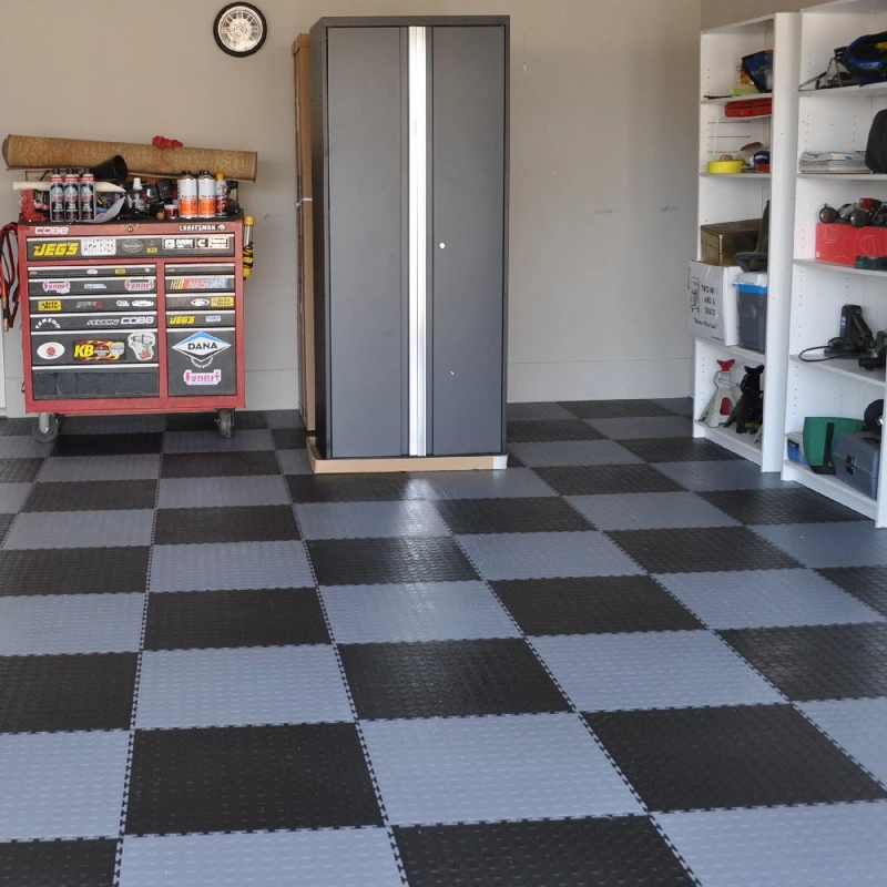 Garage Flooring Tiles 66 Black and gray checkered garage flooring tiles with storage cabinets and a toolbox.